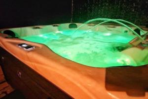 a bath tub filled with water in a room at Bounty Town House Cumbria in Whitehaven