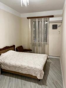 a bedroom with a bed and a window at Апартаменты с тремя спальнями in Yerevan +5 photos