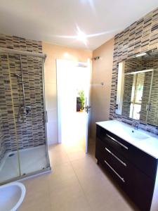 a bathroom with a shower and a sink and a tub at Magical Andalusian Vacation "Los Arcos" in Tózar