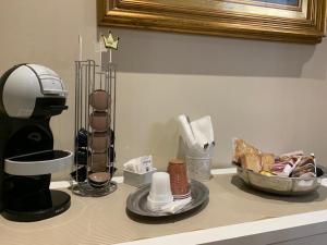 eine Theke mit einer Kaffeemaschine und anderen Gegenständen darauf in der Unterkunft Anna Rooms in Aprilia