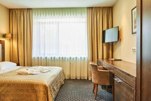 Postel nebo postele na pokoji v ubytování Grand SPA Lietuva Hotel Druskininkai