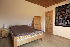 a bedroom with a bed and a painting on the wall at Willa na Wierszykach 1 in Zakopane
