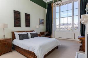 a bedroom with a bed and a large window at 21 Montpellier House - By Luxury Apartments in Cheltenham