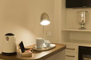 a kitchen with a table with two cups and a lamp at ICON Bcn in Barcelona