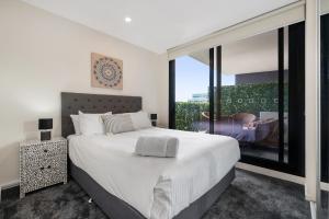 Ένα ή περισσότερα κρεβάτια σε δωμάτιο στο Melbourne City Apartments - Teri