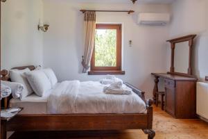 a bedroom with a bed and a window at Serene House with Backyard in Bozcaada in Canakkale