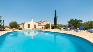 una piscina con sillas y una casa en Cortijo Rural Urrá Sorbas by Ruralidays en Sorbas