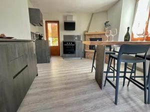 a kitchen with a table and some chairs in it at Le Due Terrazze in Brenzone sul Garda