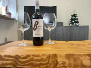 a bottle of wine and two wine glasses on a table at Le Due Terrazze in Brenzone sul Garda +29 photos