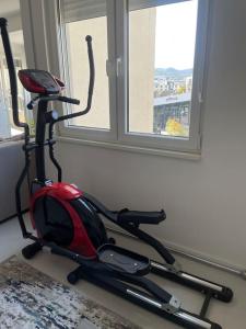 a room with a exercise bike next to a window at Spacious apartment in luxury residence in Çeliku +19 photos