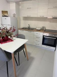 eine Küche mit einem Tisch mit Stühlen und einem Herd in der Unterkunft Spacious apartment in luxury residence in Çeliku