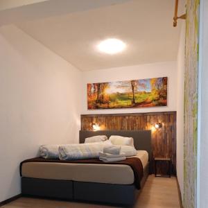 a bedroom with a bed with a painting on the wall at Ferienwohnung Heissl in Fieberbrunn