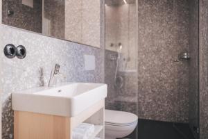 a bathroom with a sink and a toilet at Pinjola in Vandans