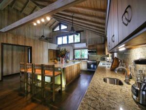 a large kitchen with a table and chairs in it at Hummingbird Beach House in West Bay