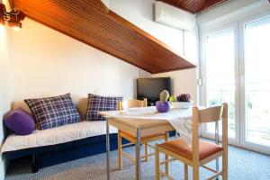 a living room with a couch and a table at Beach Guesthouse Mediteran in Podstrana