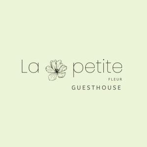 a logo for a butterfly flower guest house at La Petite Fleur Guesthouse in Xylokastron