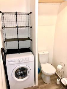 a small bathroom with a washing machine and a toilet at Le Mécanique Room centre ville, parking gratuit in Sens +9 photos