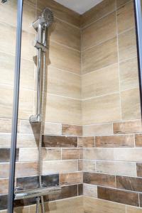 a shower in a bathroom with wooden tiles at 4 Bed, 3 Bath Apartment in City Centre in Portsmouth