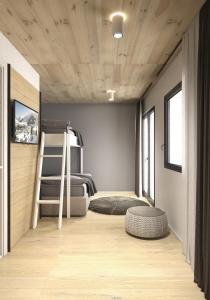a bedroom with a bunk bed and a ladder at The Base Andermatt in Andermatt