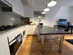 a kitchen with a table and a stove at Oktheway Santander Street in A Coruña +13 photos