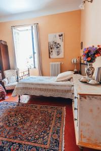 a bedroom with a bed and a table and a window at B&B en Provence- Villa Saint Marc in Forcalquier