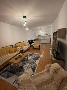 a living room with two couches and a table at Lovely apartment in Peja Citycenter in Peje