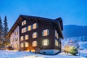 a large house in the snow in the winter at Hotel Sonne in Brand