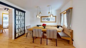 a dining room with a wooden table and chairs at Tschuetta in Celerina