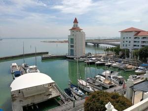 a marina with boats in the water next to buildings at Lucky Waterfront at Straits Quay Seaview or Non in Bagan Jermal