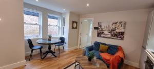 a living room with a couch and a table at Ritual Stays stylish 1-Bed Flat in the Heart of St Albans City Centre with Working Space and Super Fast WiFi in Saint Albans