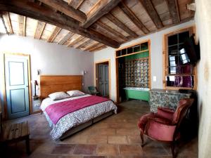 a bedroom with a bed and a chair at LA CASA DE BOULBON in Boulbon