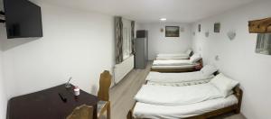 a row of white couches in a room at Casa Maria in Vişeu de Sus