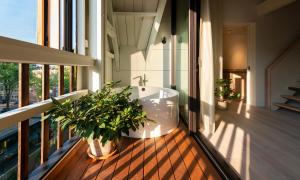 a bathroom with a bath tub on a balcony at Hotel Arena in Amsterdam