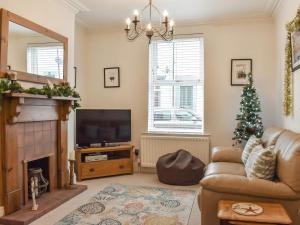 a living room with a christmas tree and a couch at Sunstar Cottage in Whitby