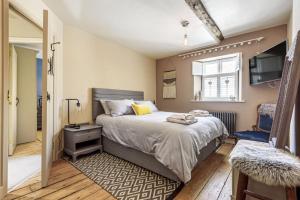 a bedroom with a large bed and a television at The Mustard Pot - Kirkby Lonsdale in Kirkby Lonsdale