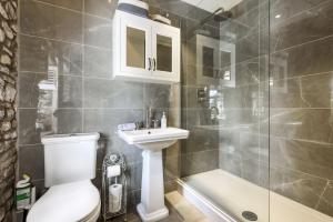 a bathroom with a toilet and a sink and a shower at The Mustard Pot - Kirkby Lonsdale in Kirkby Lonsdale +12 photos