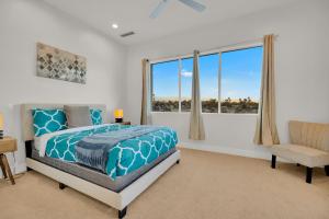 a bedroom with a bed and a window and a chair at Gateway Luxury Resort Style With A Private Pool in Palm Springs