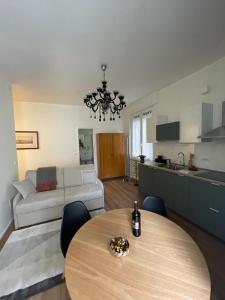 a living room with a table and a couch at Palazzo Penco Apartment in Genoa +14 photos