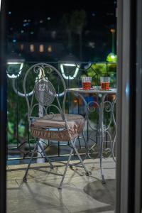 a chair and a table on a balcony at Alloggio nuovissimo al centro e rilassante in Ischia