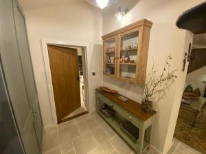 a hallway with a wooden cabinet and a door at Gower Villa Luxury Cottage, 2 bedroom en-suite with Hot Tub in Clynderwen