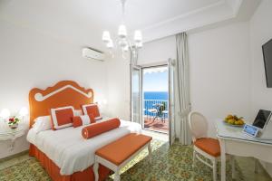 a bedroom with a bed with a view of the ocean at Open Gate in Praiano