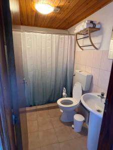 a bathroom with a toilet and a sink at Baia Seixal Oceanfront in Seixal