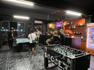 a group of people playing a game of pool in a bar at Bong Hostel and Motorbike Tour in Ha Giang