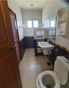 a bathroom with a toilet and a sink at Maerim​ relax in Mae Rim