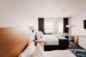 Postel nebo postele na pokoji v ubytování La Place Rendez-Vous Hotel