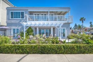 a white house with a balcony and a garden at Ocean Views, Across The Street From Beach, Private Patio in Carlsbad