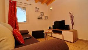 a living room with a couch and a television at Holiday Home Bili Žal in Vela Luka +127 photos