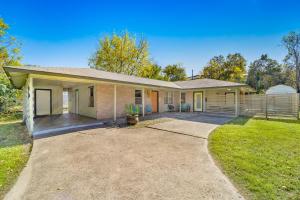 a home with a large driveway in front of it at Pet-friendly Duplex, Big Shared Yard in Charming Historic Travis Heights! in Austin