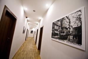 a painting of a man in a black and white photo at SasOne Rooms in Budapest