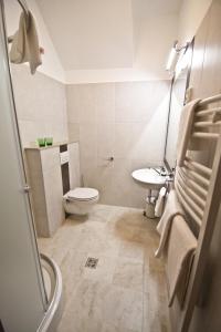 a bathroom with a toilet and a sink at SasOne Rooms in Budapest